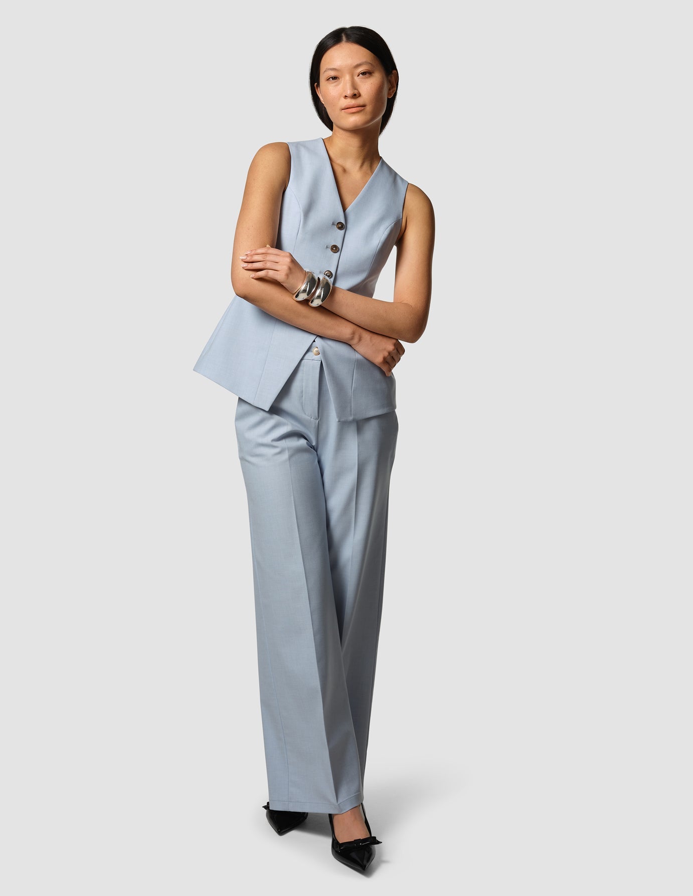 Woman wearing a light blue suit with a white background